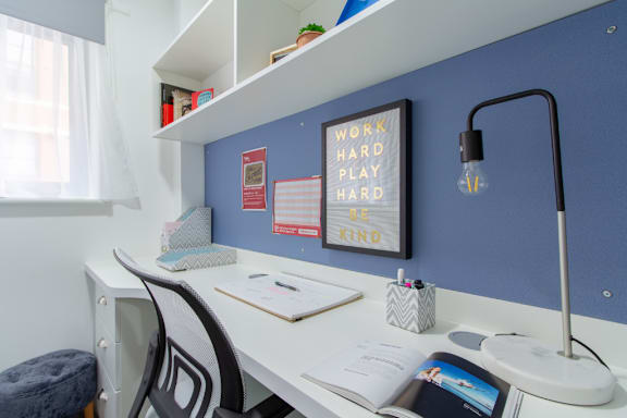 Floor Plan  a home office with a desk and chair and a bulletin board