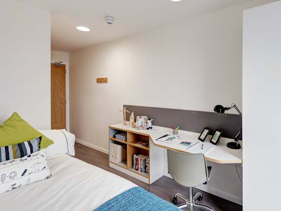 Floor Plan  A bedroom with a bed, desk, and chair.