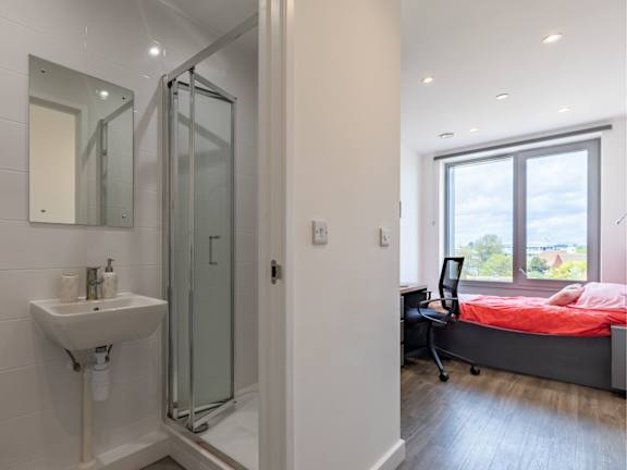 Floor Plan  A bathroom with a sink, mirror, and shower.