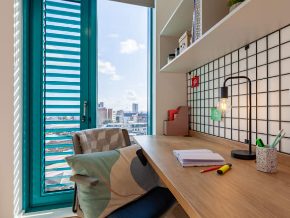 Floor Plan  a home office with a desk and a window
