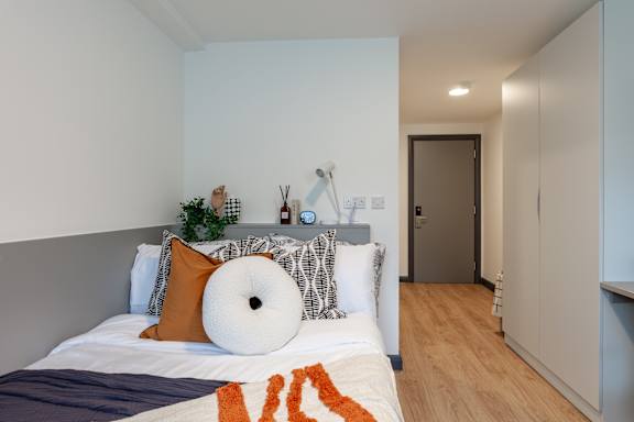 Floor Plan  a bedroom with a bed with pillows and aificantificantificant amount of furniture