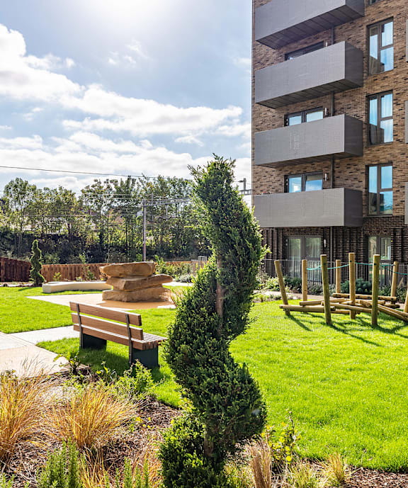 A modern building with a green lawn in front.