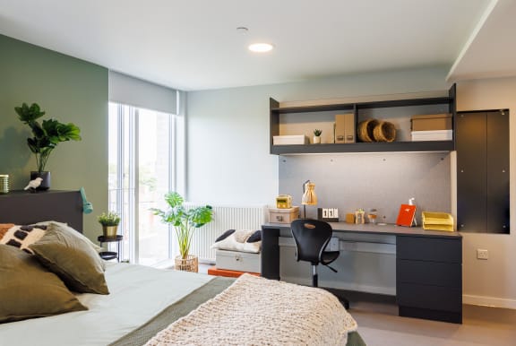 Floor Plan  a small bedroom with a desk and a bed