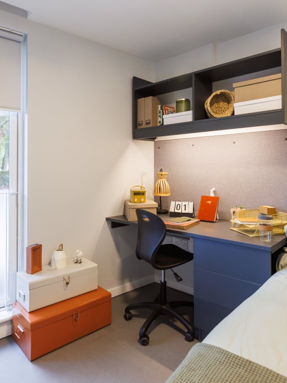 Floor Plan  a bedroom with a desk and a chair and a bed