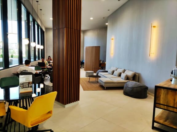 a living room filled with furniture and large windows