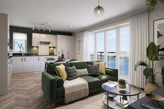 A living room with a green couch and a coffee table.