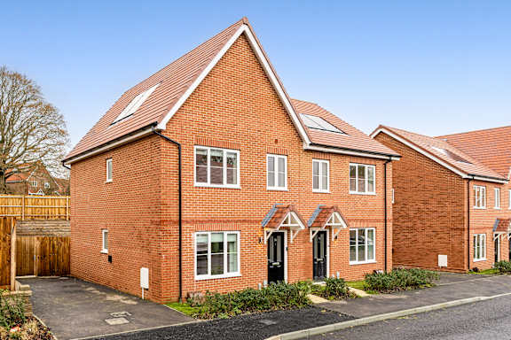 A red brick house with a black door and windows.