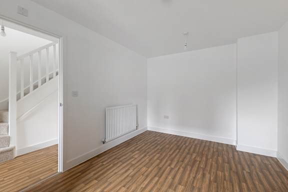 A room with wooden floors and white walls.