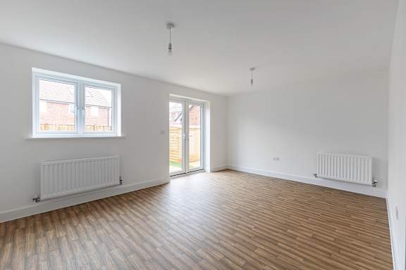A room with wooden floors and white walls.