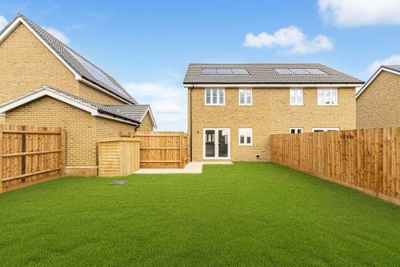 A house with a green lawn in front.
