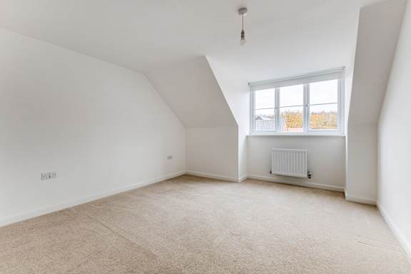A room with a window and a radiator on the wall.