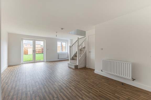 A room with wooden floors and white walls.