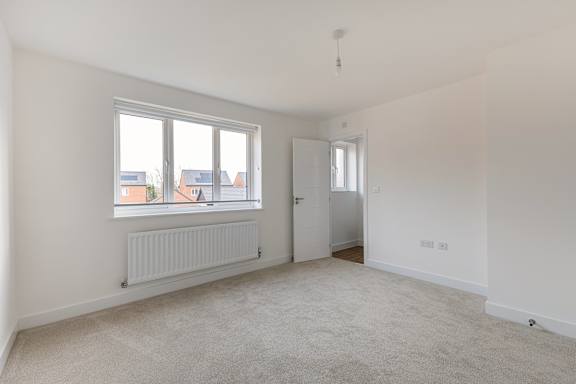 A white room with a window and a door.