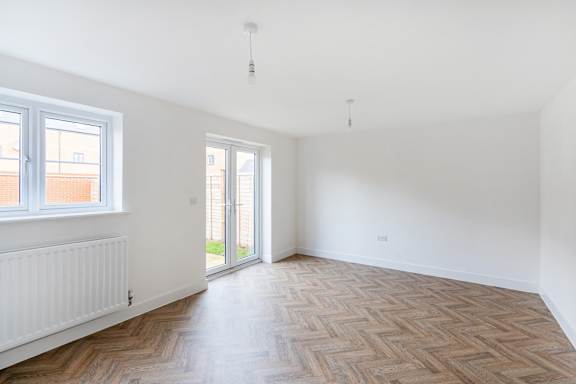 A room with a wooden floor and a window.