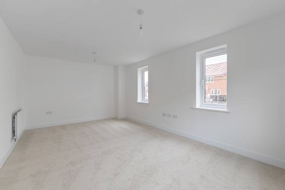 Empty room with white walls and a window.