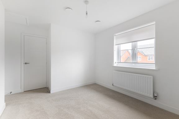 A white room with a door and a window.