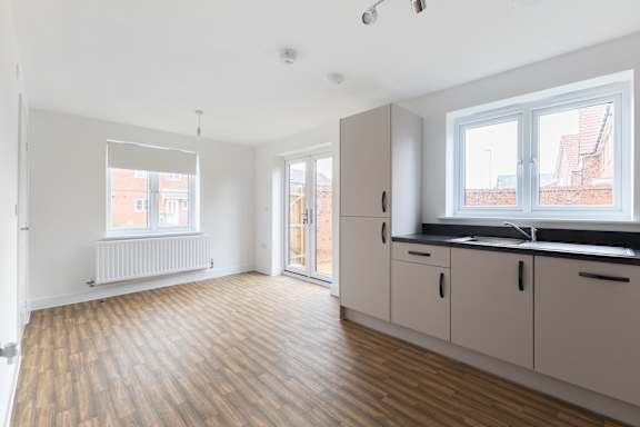 A room with wooden floors and white walls.