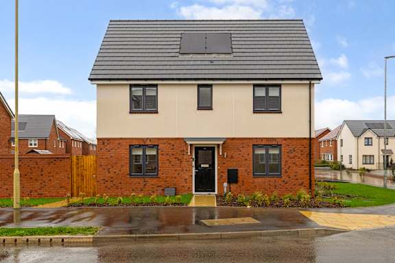 A house with a grey roof and a black door.