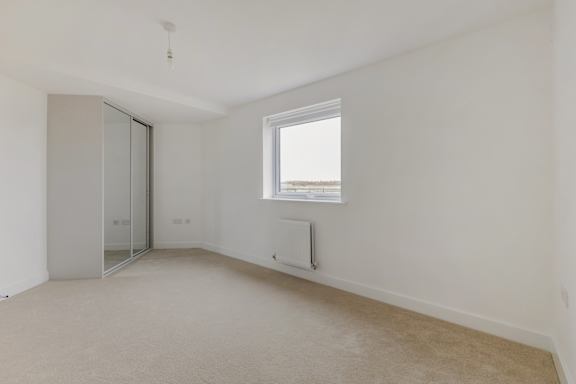 A room with a window and a sliding door.