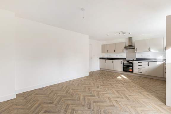 A kitchen with a herringbone patterned floor.