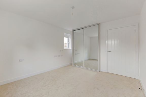 A room with a white door and a glass door.