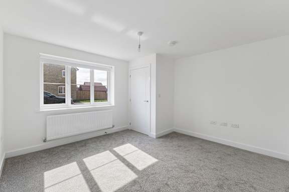 A room with a window and a door.