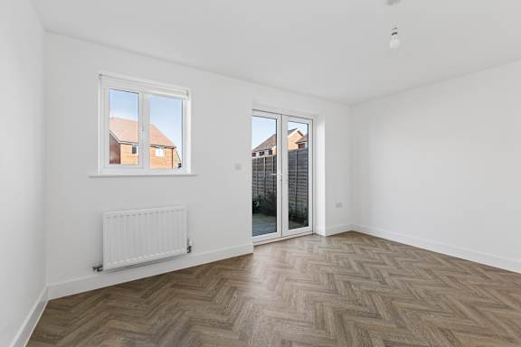 A room with a window and a door leading outside.