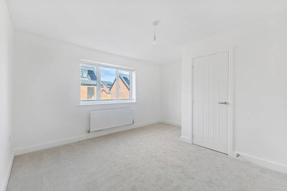 A white room with a window and a door.