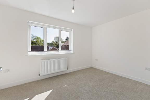 A room with a window and a radiator on the wall.