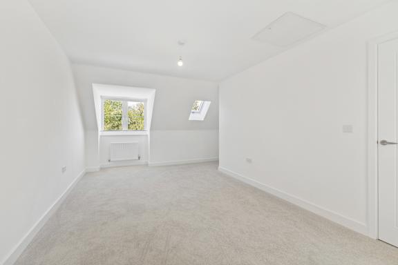A white room with a window and a door.