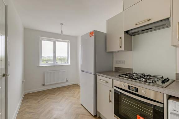A kitchen with a stove, oven, and refrigerator.