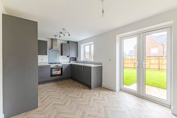 A kitchen with a large island and a dining table.