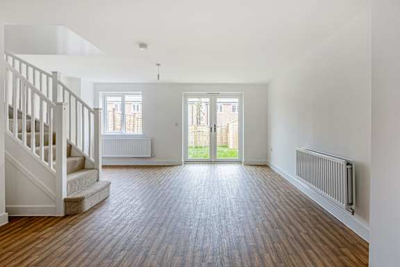 A room with wooden floors and white walls.