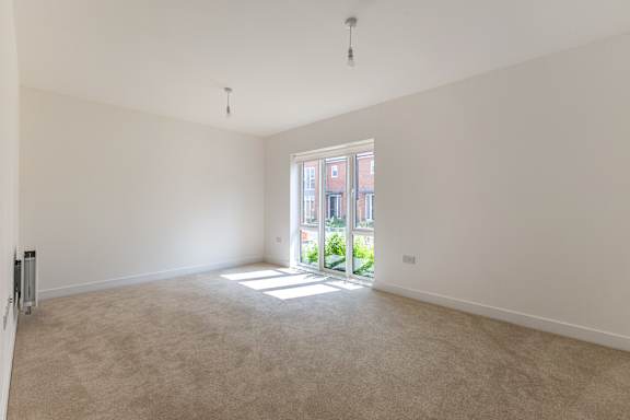 A large, empty room with a door leading outside.