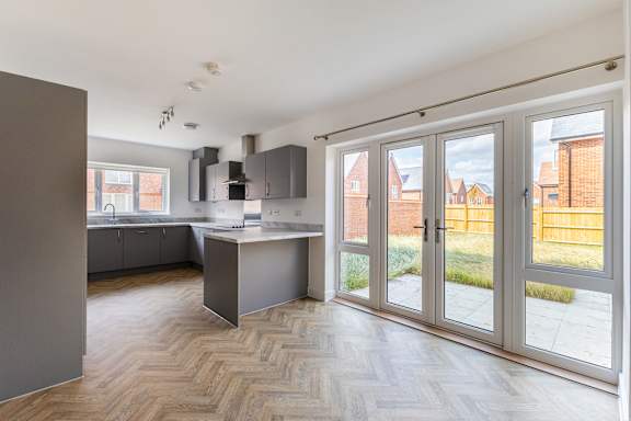 A kitchen with a table and chairs and a window.