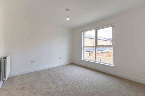 A room with a window overlooking a building.