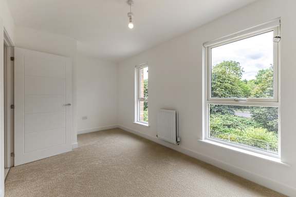 A room with a window and a radiator.