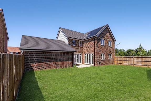 A house with a green lawn in front.