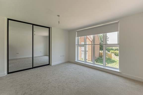 A room with a large window and a sliding door.
