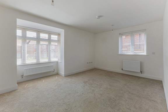 A room with a window and a radiator on the wall.