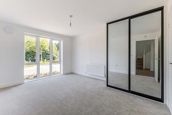 A room with a sliding glass door leading to a backyard.