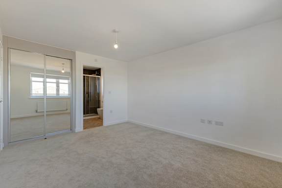 A large, empty room with a sliding glass door.