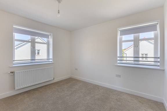 A room with a window and a radiator on the wall.