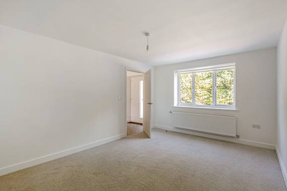 A room with a window and a door.