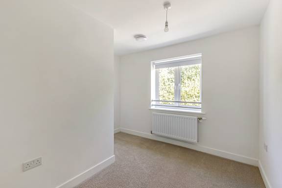A room with a window and a radiator.