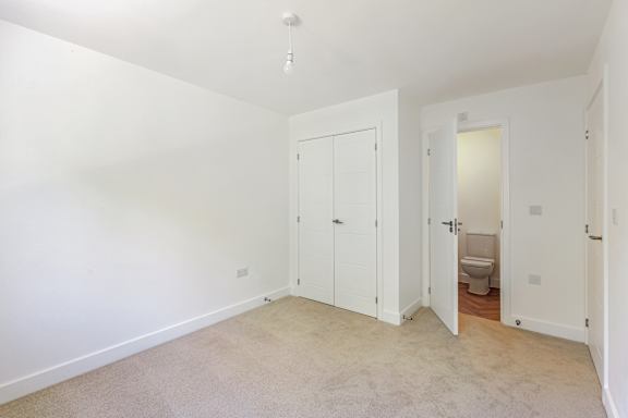 A white room with a toilet in the corner.