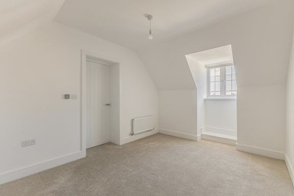 A white room with a window and a door.