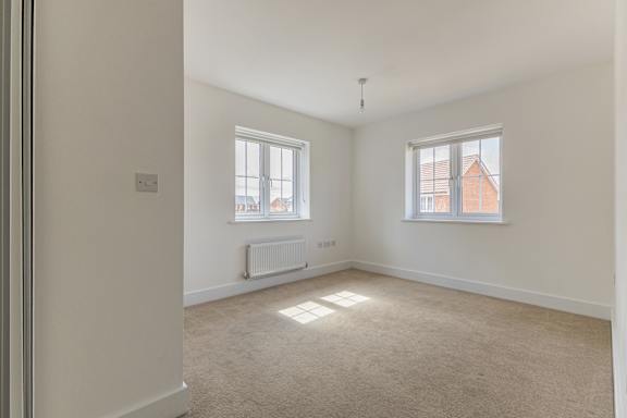 A room with a window and a radiator on the wall.