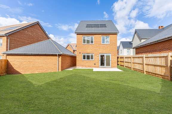 A house with a green lawn in front.