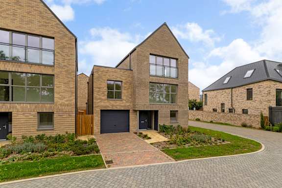A modern house with a brick facade and a driveway.